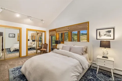 a bedroom with a balcony a bed and a couch