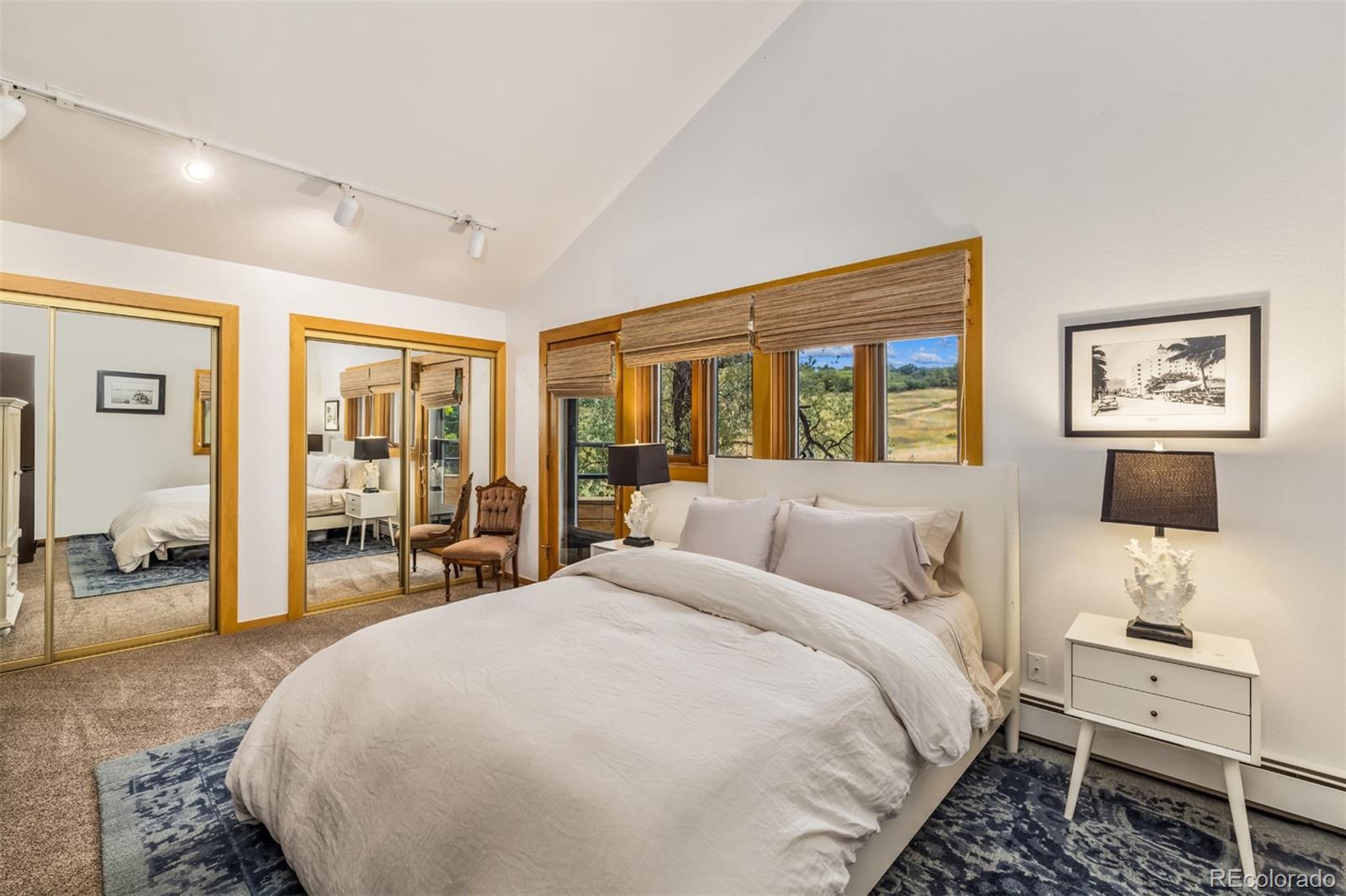 6 Blue Grouse Ridge Road Littleton, CO 80127 - Photo 37 of 50 a spacious bedroom with a large bed and a desk