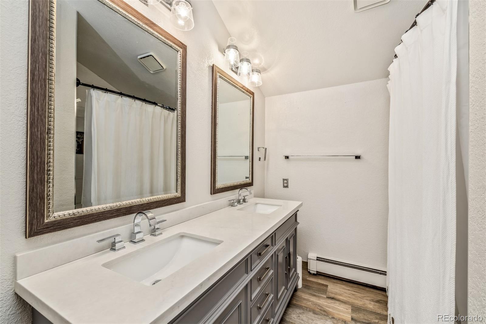6 Blue Grouse Ridge Road Littleton, CO 80127 - Photo 39 of 50 a bathroom with a sink and a mirror
