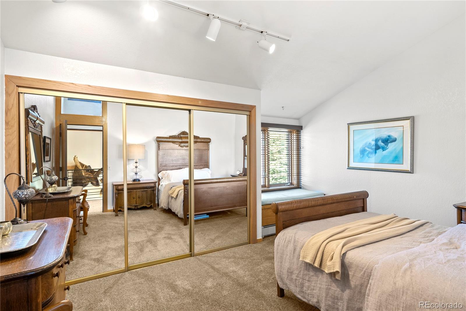 6 Blue Grouse Ridge Road Littleton, CO 80127 - Photo 40 of 50 a bedroom with a balcony a bed and a couch