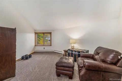 a view of a patio with couches and table and chairs and potted plants