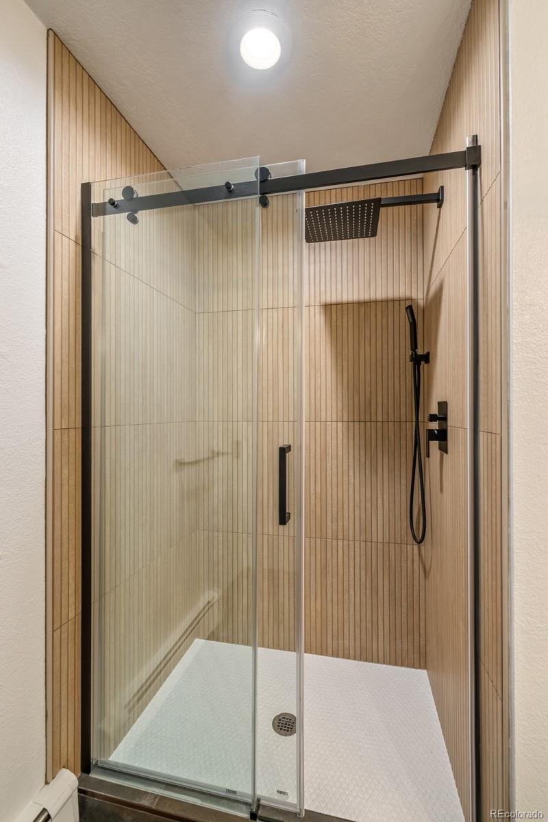 6 Blue Grouse Ridge Road Littleton, CO 80127 - Photo 44 of 50 a bathroom with a glass shower door