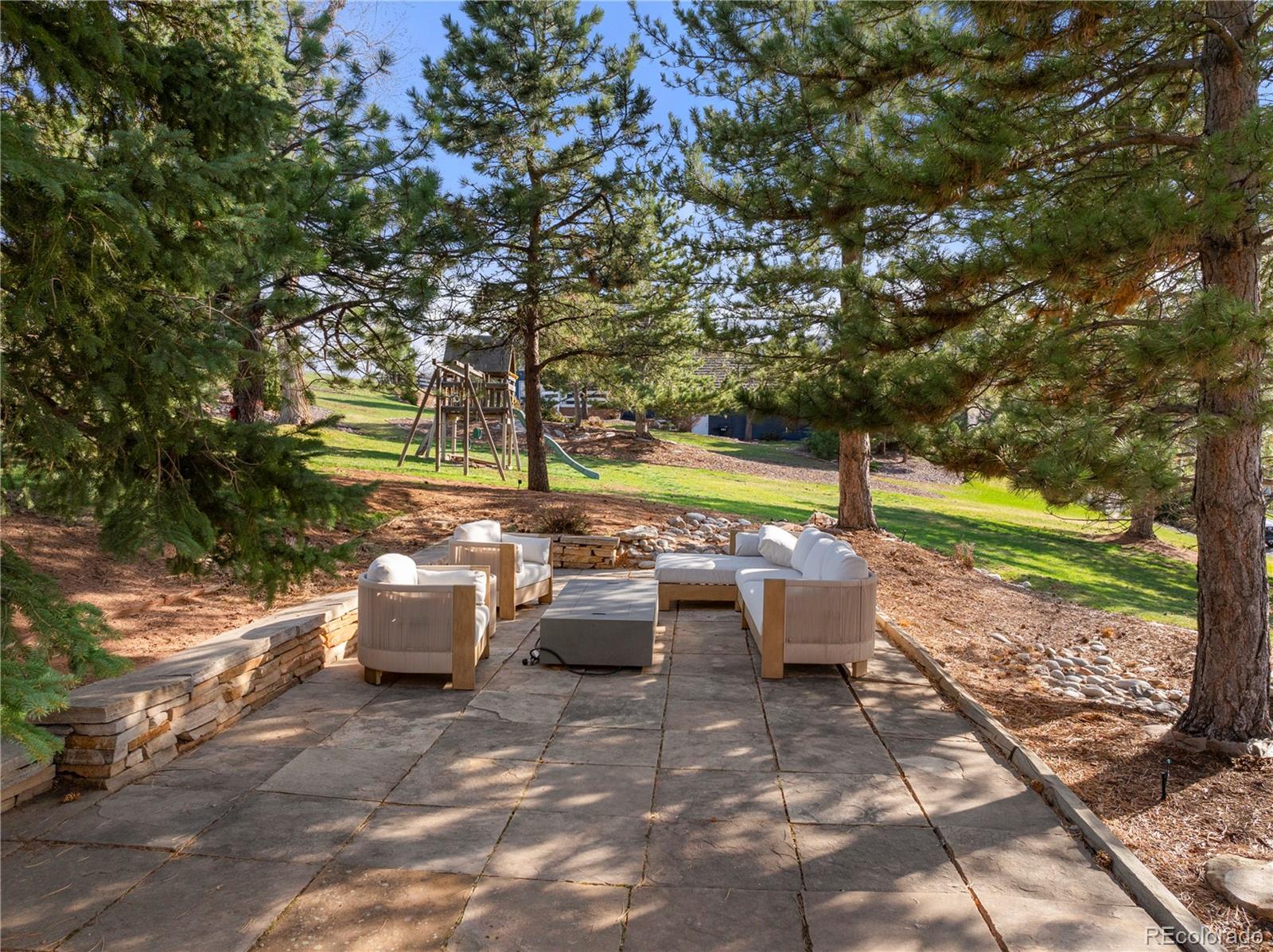 6 Blue Grouse Ridge Road Littleton, CO 80127 - Photo 45 of 50 a view of a patio with couches and table and chairs and potted plants