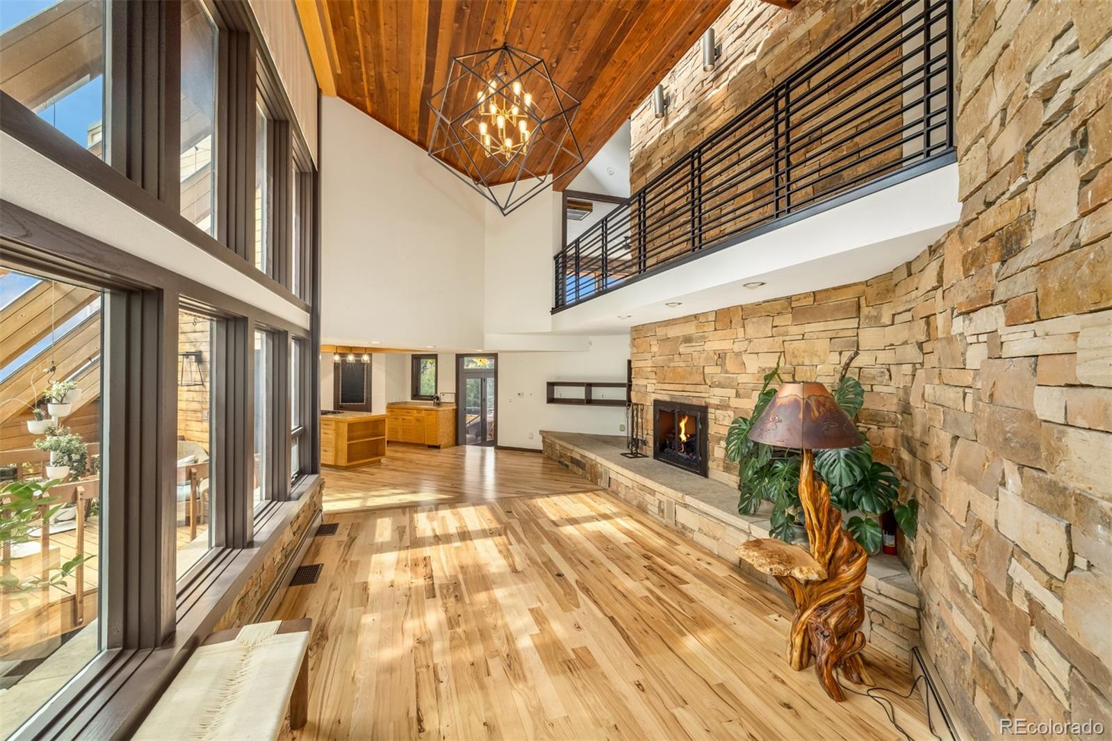 6 Blue Grouse Ridge Road Littleton, CO 80127 - Photo 8 of 50 a view of a balcony with furniture and a fireplace