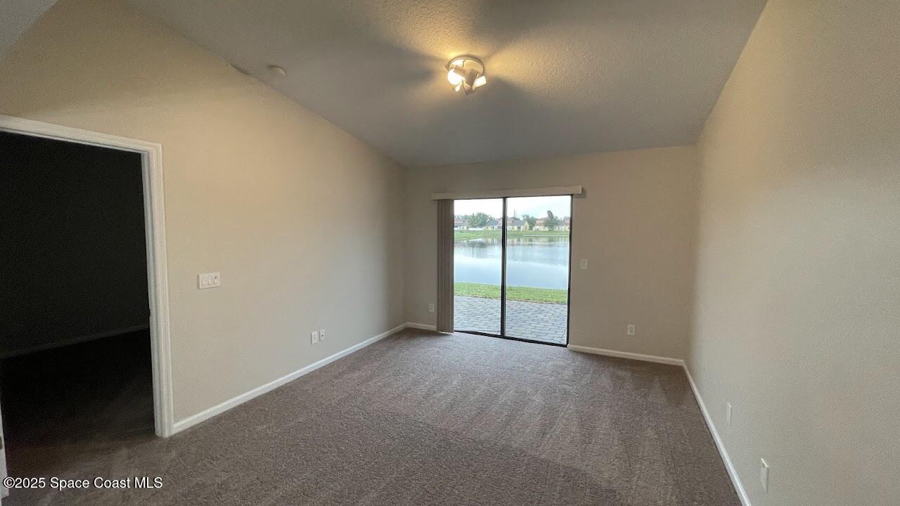975 Luminary Circle, Unit 103 Melbourne, FL 32901 - Photo 13 of 70 a view of an empty room with a window