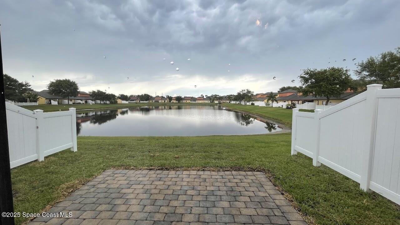 975 Luminary Circle, Unit 103 Melbourne, FL 32901 - Photo 14 of 70 a view of a lake with houses in the background
