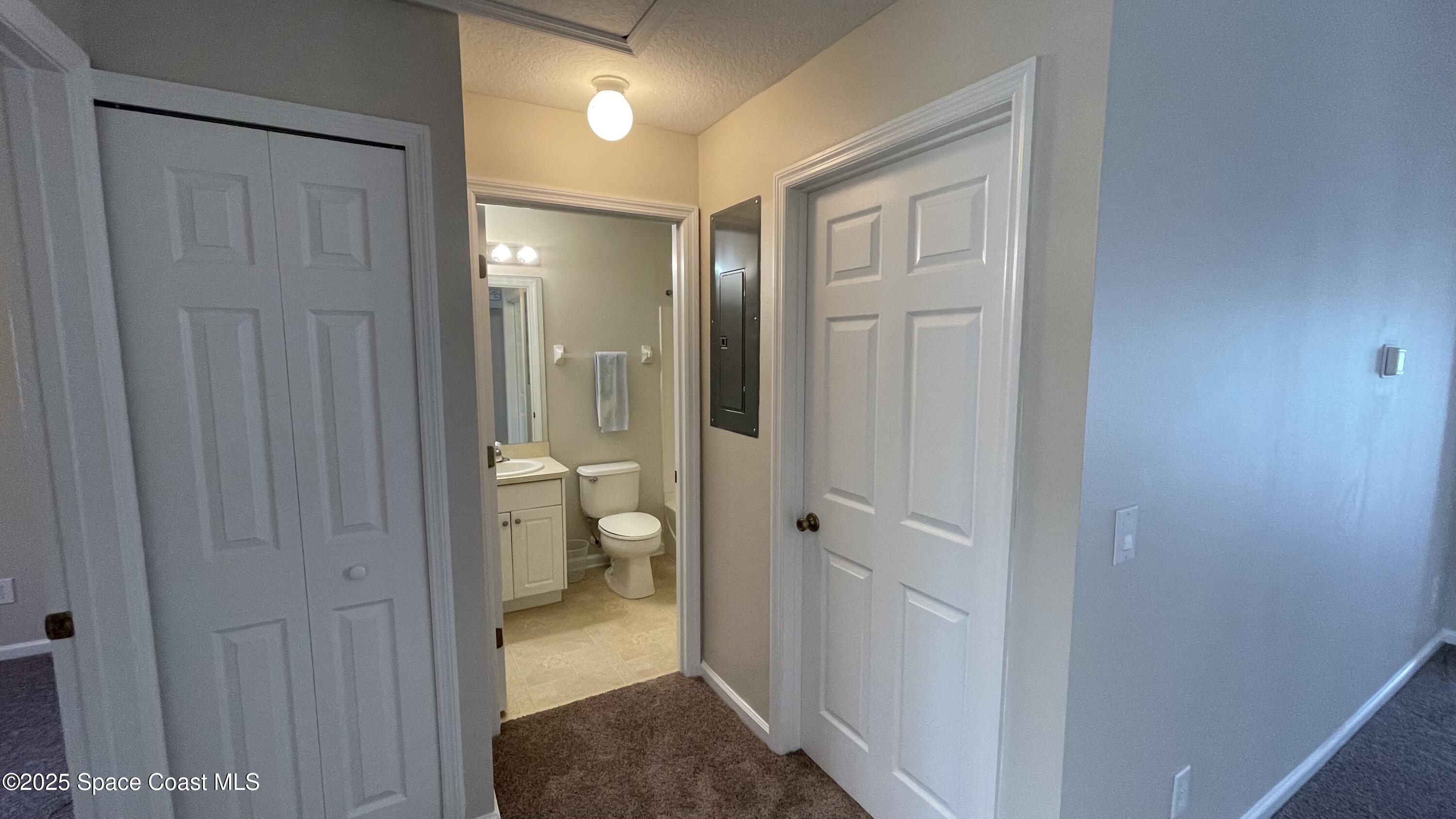 975 Luminary Circle, Unit 103 Melbourne, FL 32901 - Photo 28 of 70 a view of a bathroom from a hallway