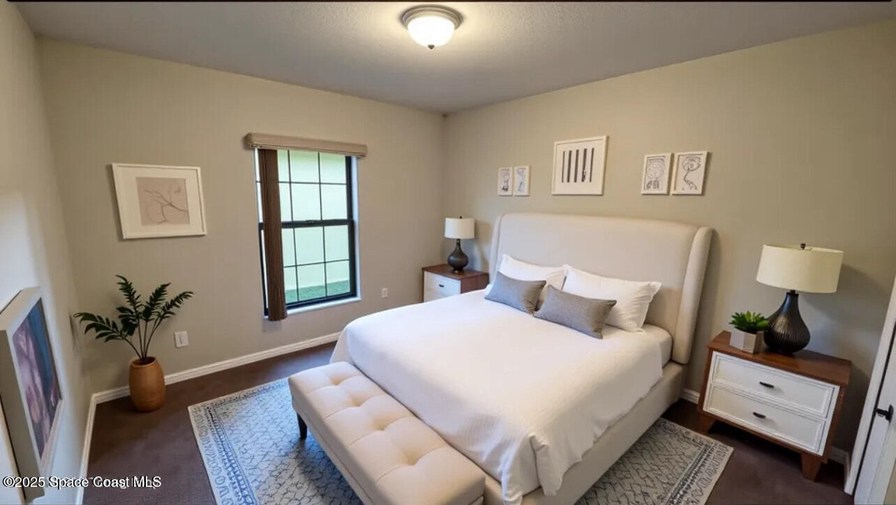 975 Luminary Circle, Unit 103 Melbourne, FL 32901 - Photo 30 of 70 a bedroom with a large bed and a window