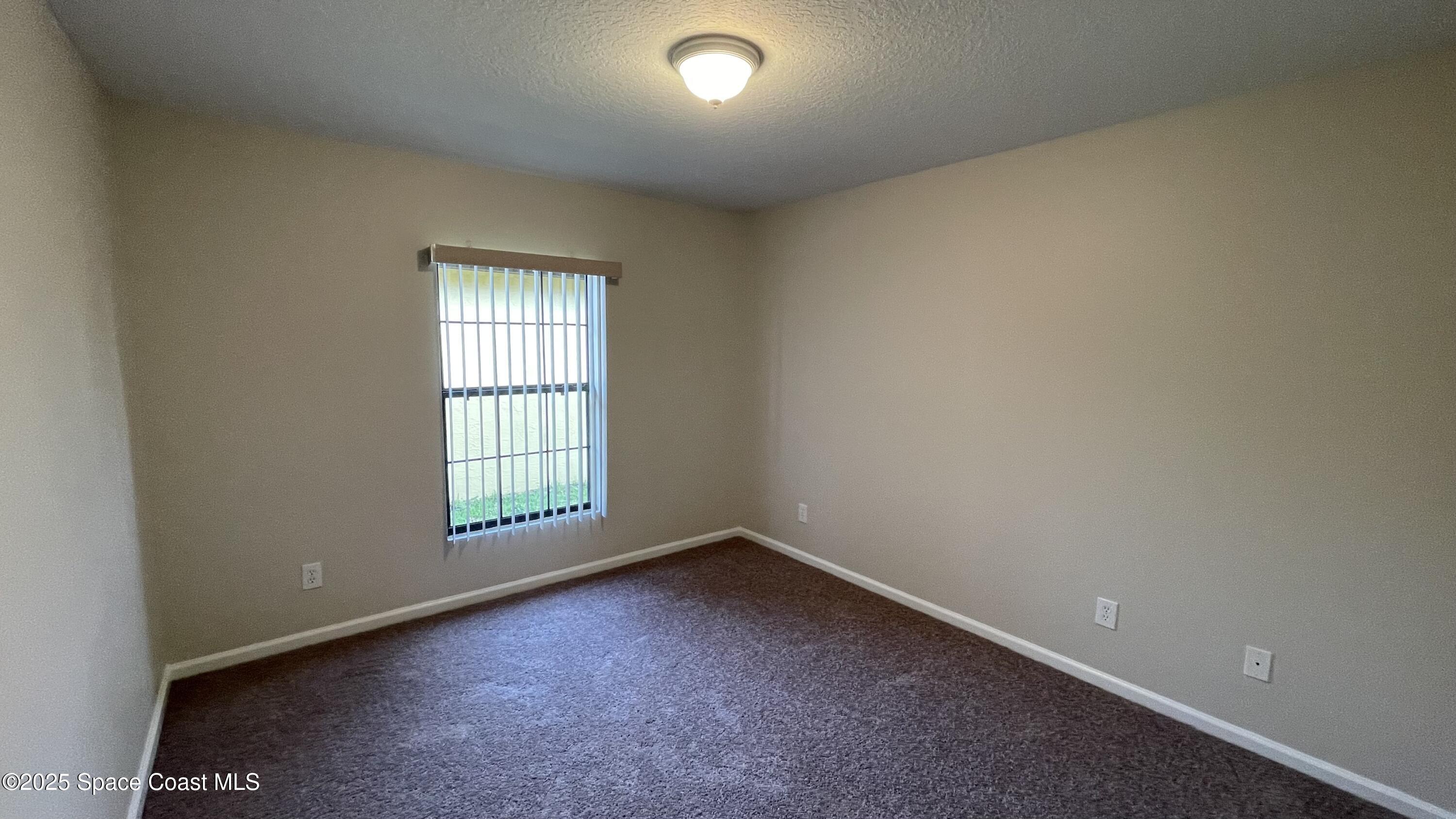 975 Luminary Circle, Unit 103 Melbourne, FL 32901 - Photo 32 of 70 an empty room with a window