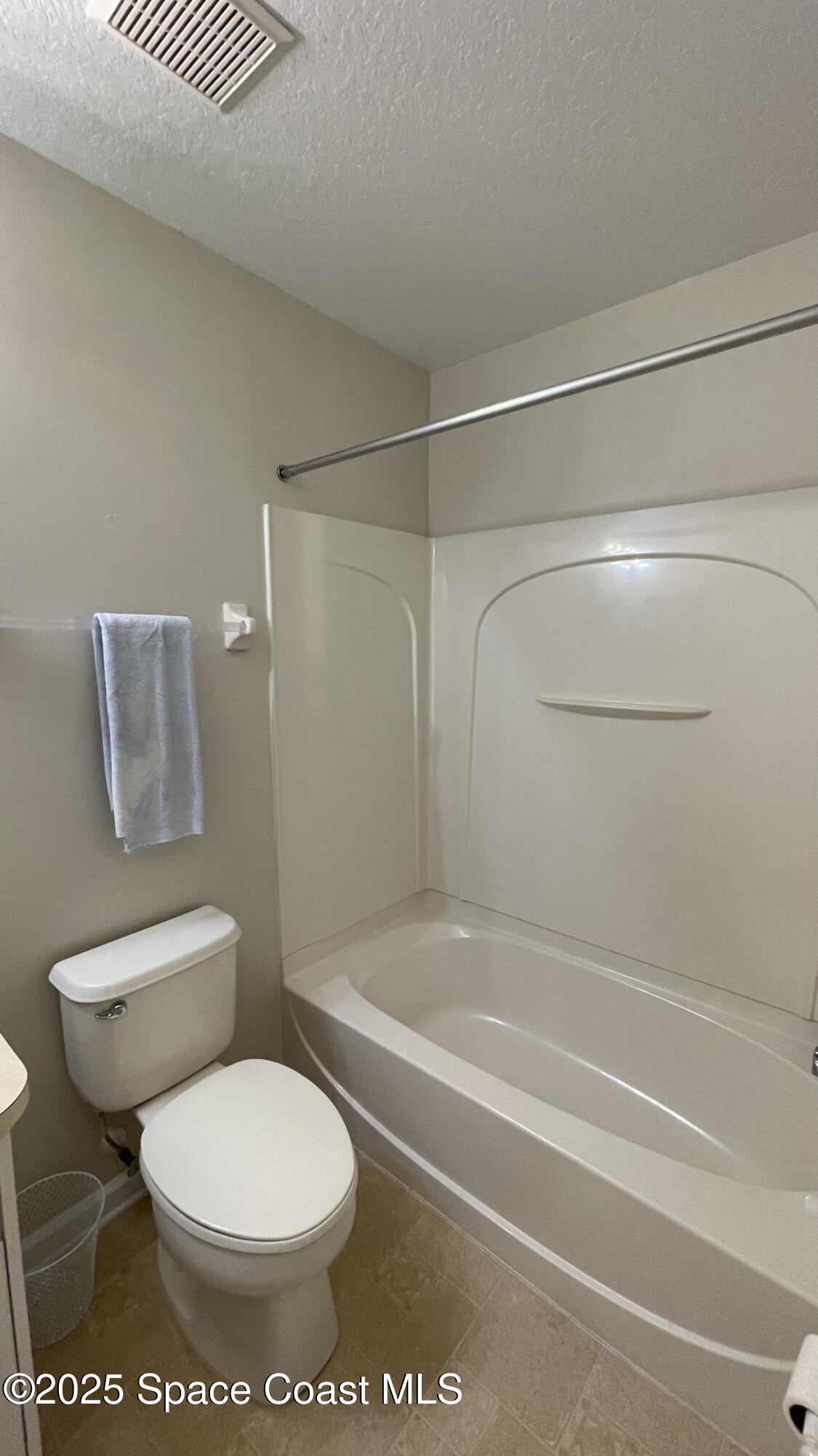 975 Luminary Circle, Unit 103 Melbourne, FL 32901 - Photo 33 of 70 a bathroom with a toilet and a shower