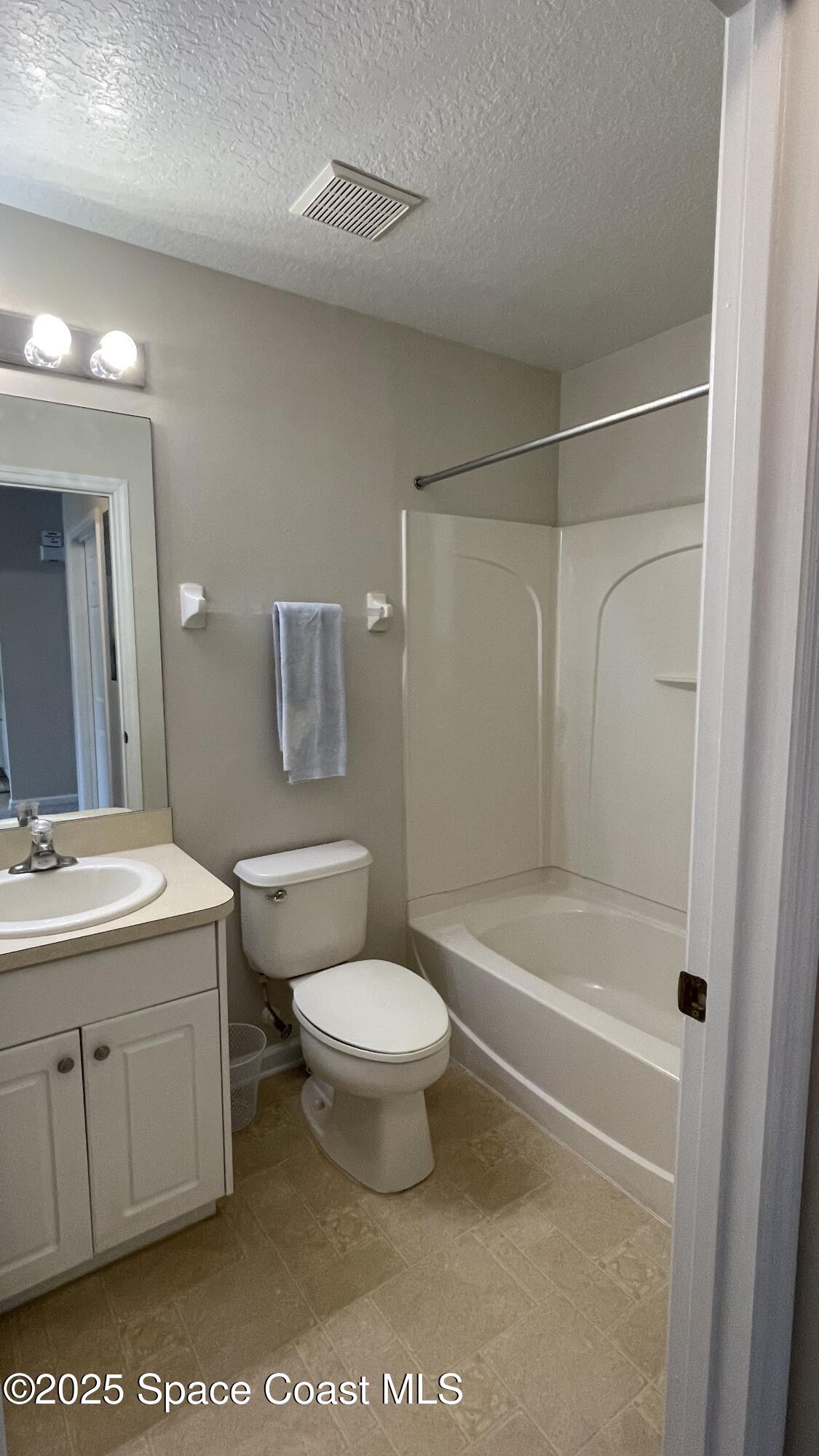 975 Luminary Circle, Unit 103 Melbourne, FL 32901 - Photo 35 of 70 a bathroom with a sink a toilet and shower