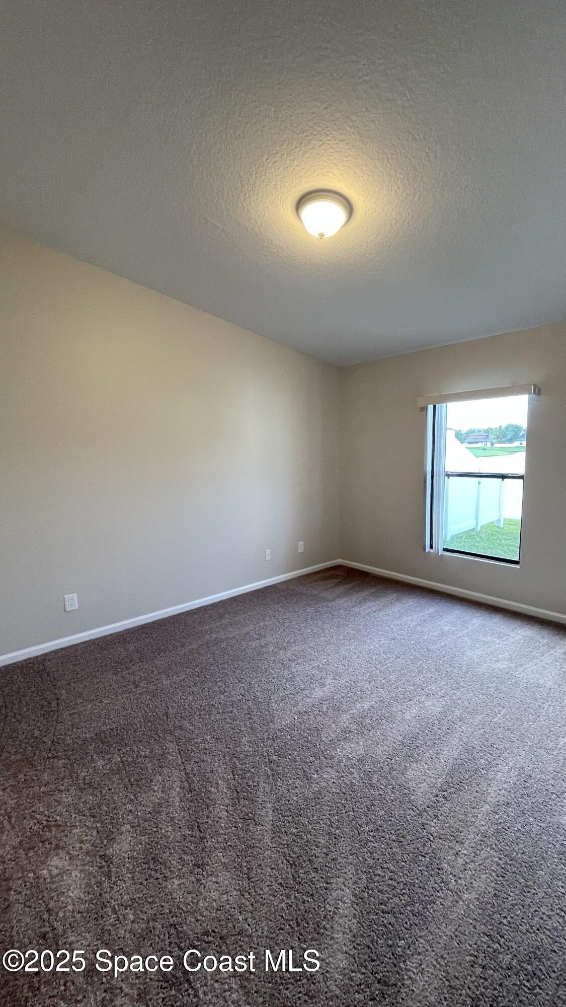 975 Luminary Circle, Unit 103 Melbourne, FL 32901 - Photo 49 of 70 an empty room with a empty space and windows