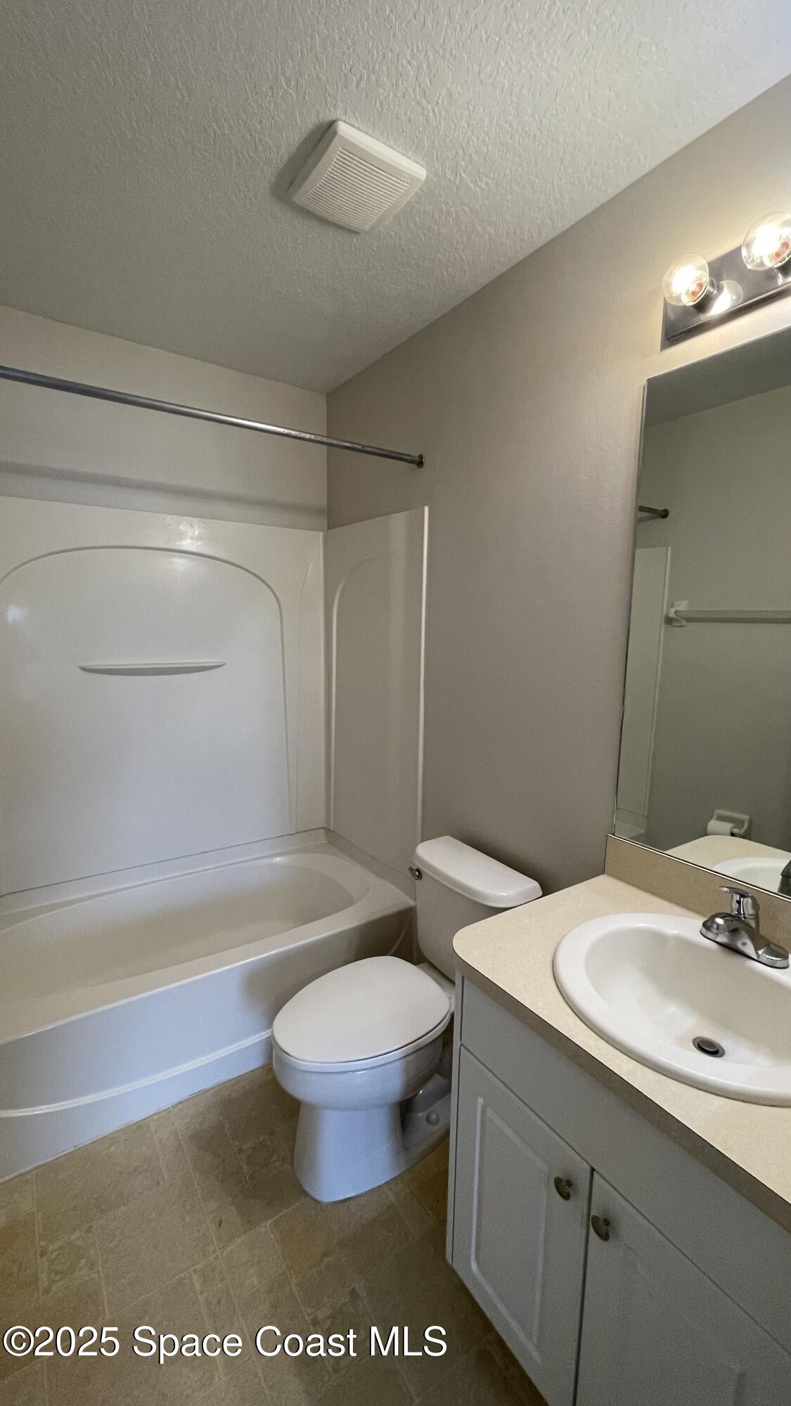 975 Luminary Circle, Unit 103 Melbourne, FL 32901 - Photo 52 of 70 a bathroom with a sink a toilet and a bathtub