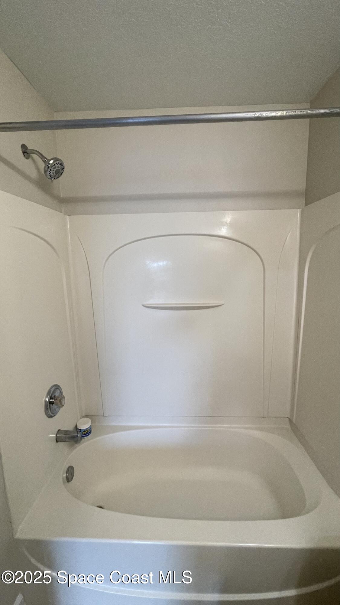 975 Luminary Circle, Unit 103 Melbourne, FL 32901 - Photo 53 of 70 a bathroom with a shower and a bath tub