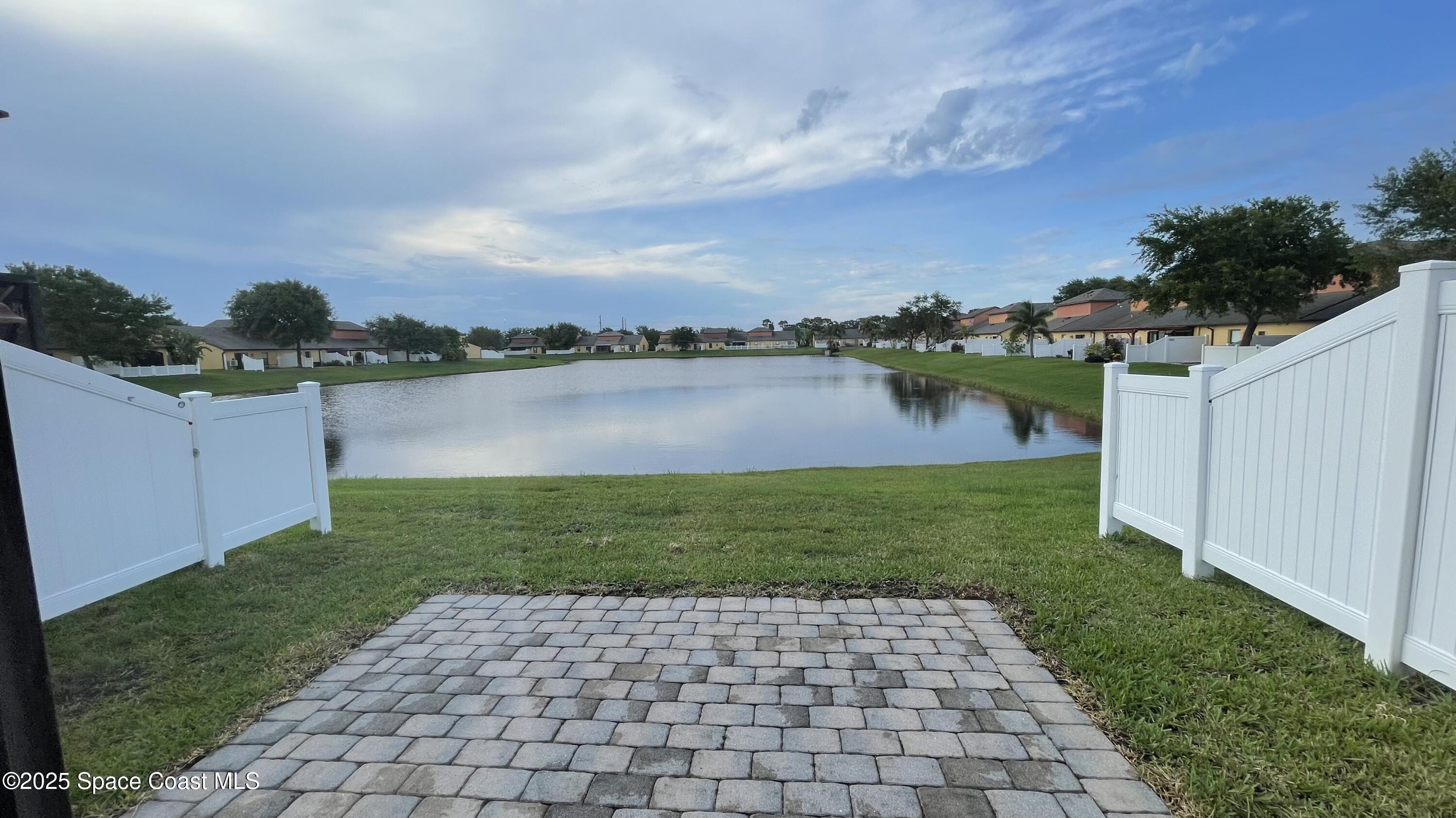 975 Luminary Circle, Unit 103 Melbourne, FL 32901 - Photo 57 of 70 a view of a lake from a yard
