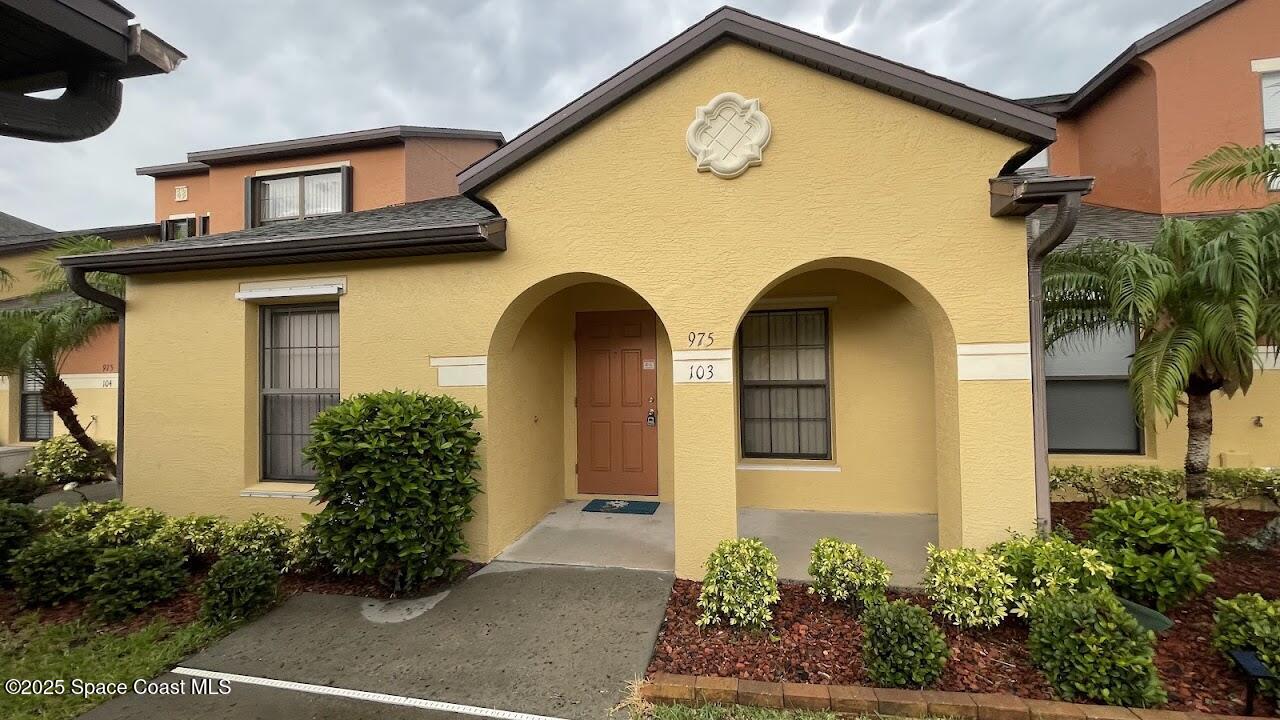 975 Luminary Circle, Unit 103 Melbourne, FL 32901 - Photo 5 of 70 a view of a house with a entryway and plants