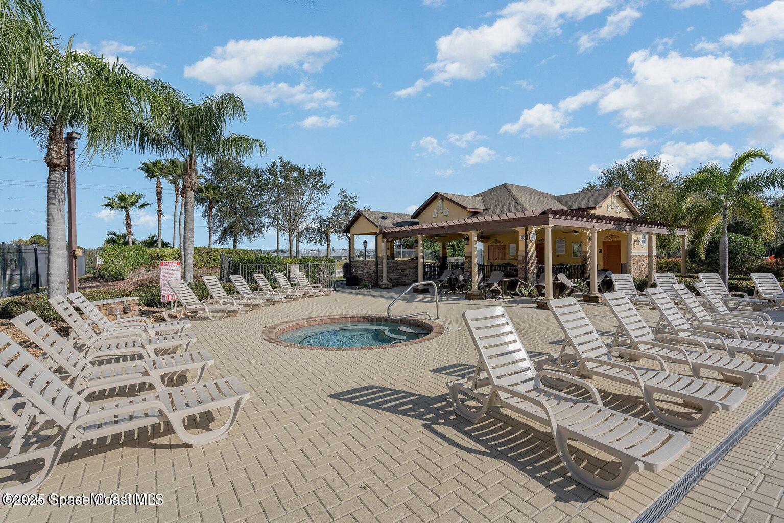 975 Luminary Circle, Unit 103 Melbourne, FL 32901 - Photo 65 of 70 a view of a house with swimming pool and sitting area
