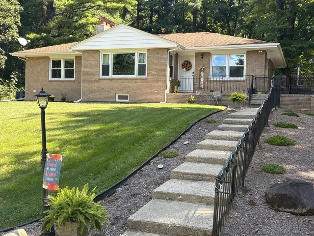 a front view of house with yard and green space