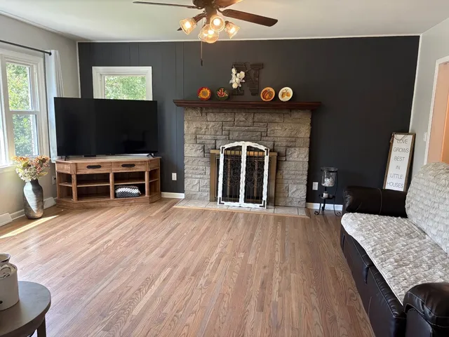 a living room with furniture a fireplace and a flat screen tv