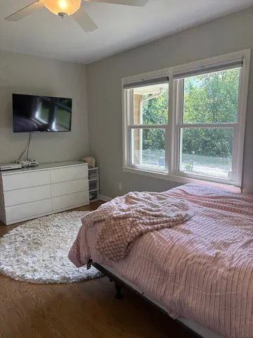 a bedroom with a bed and large window