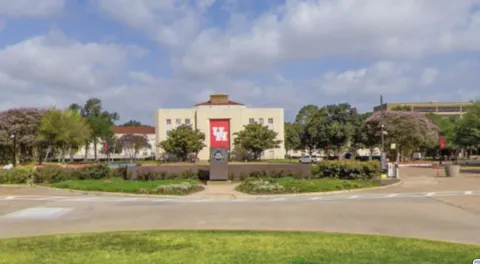 a front view of a house with a yard and a garage