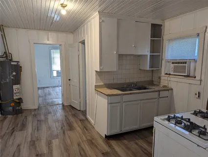 a kitchen that has a sink and a stove in it
