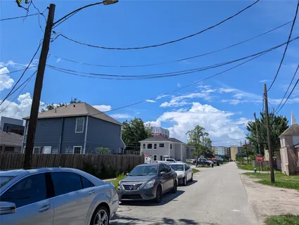 a front view of a house with cars parked