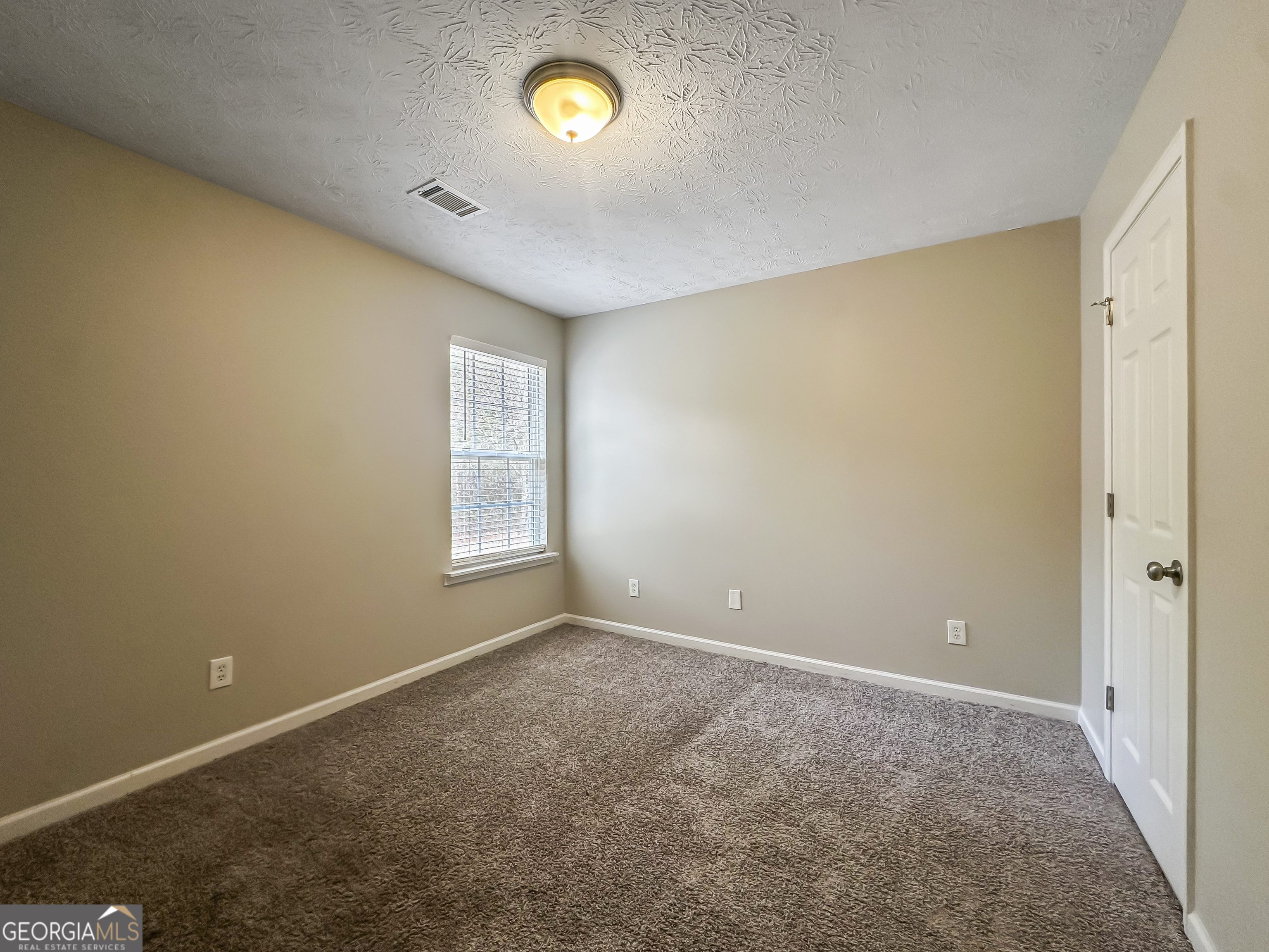1395 Stephens Pond View Loganville, GA 30052 - Photo 13 of 20 a view of an empty room with a window