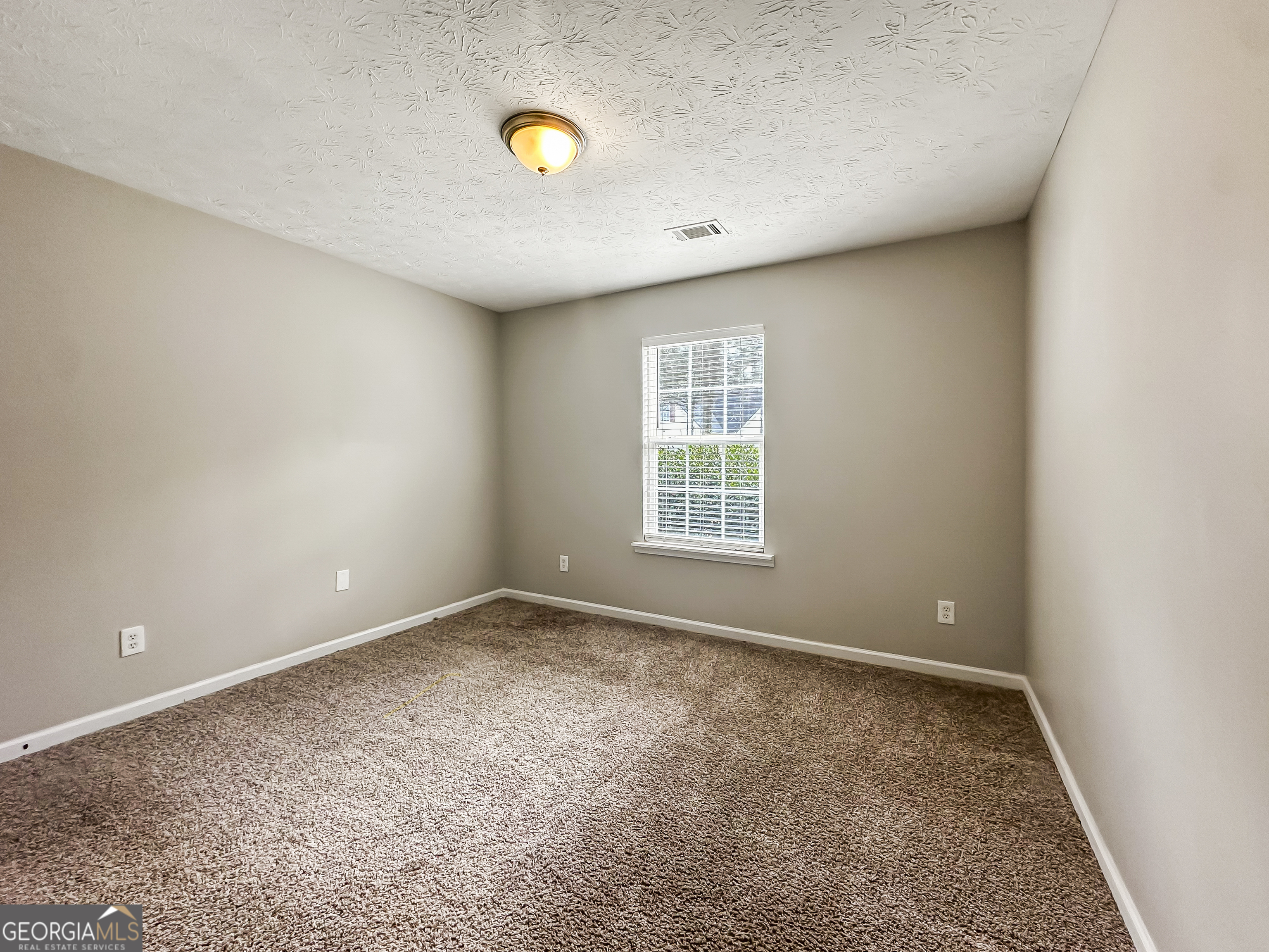 1395 Stephens Pond View Loganville, GA 30052 - Photo 15 of 20 an empty room with windows