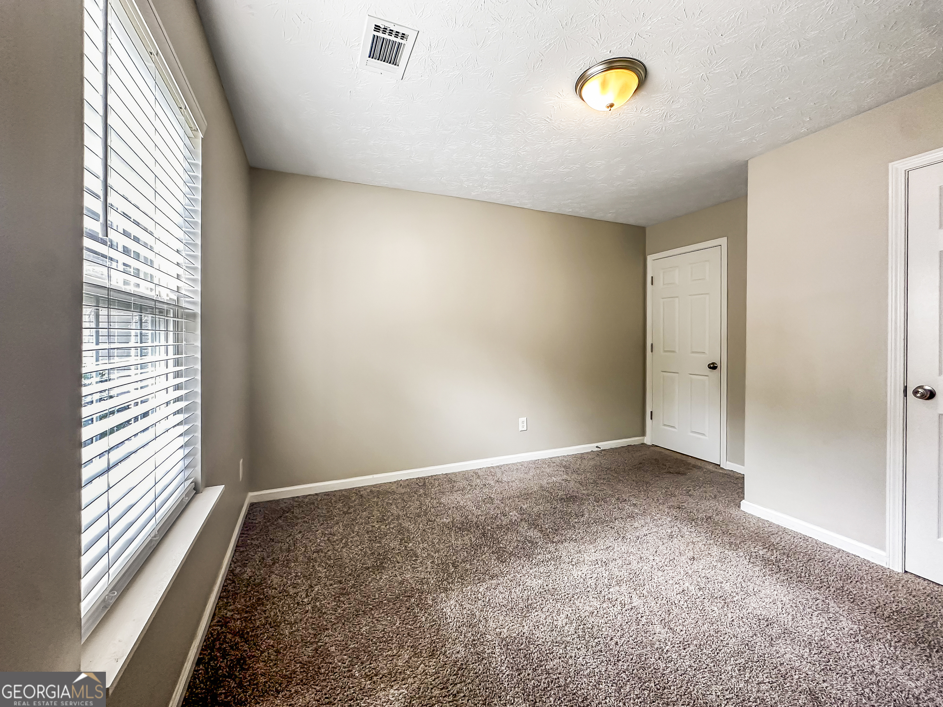 1395 Stephens Pond View Loganville, GA 30052 - Photo 16 of 20 a view of an empty room with a window