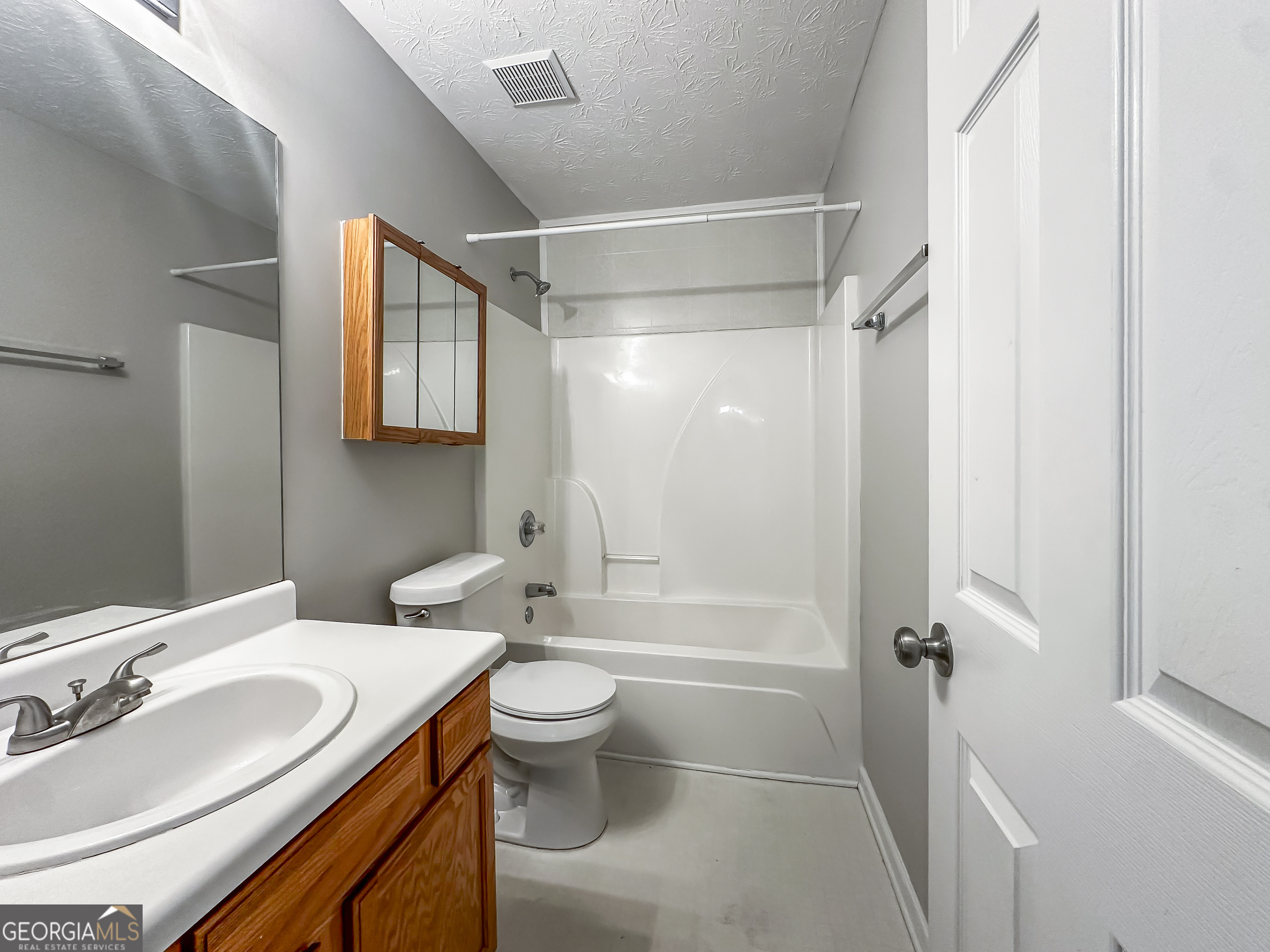 1395 Stephens Pond View Loganville, GA 30052 - Photo 17 of 20 a bathroom with a sink a toilet and shower