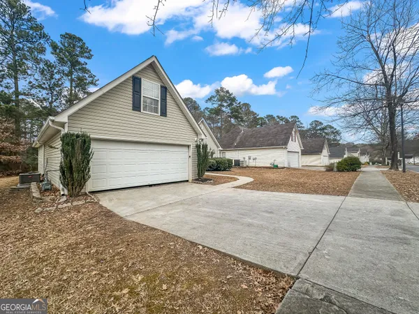 a view of a house with a yard and garage