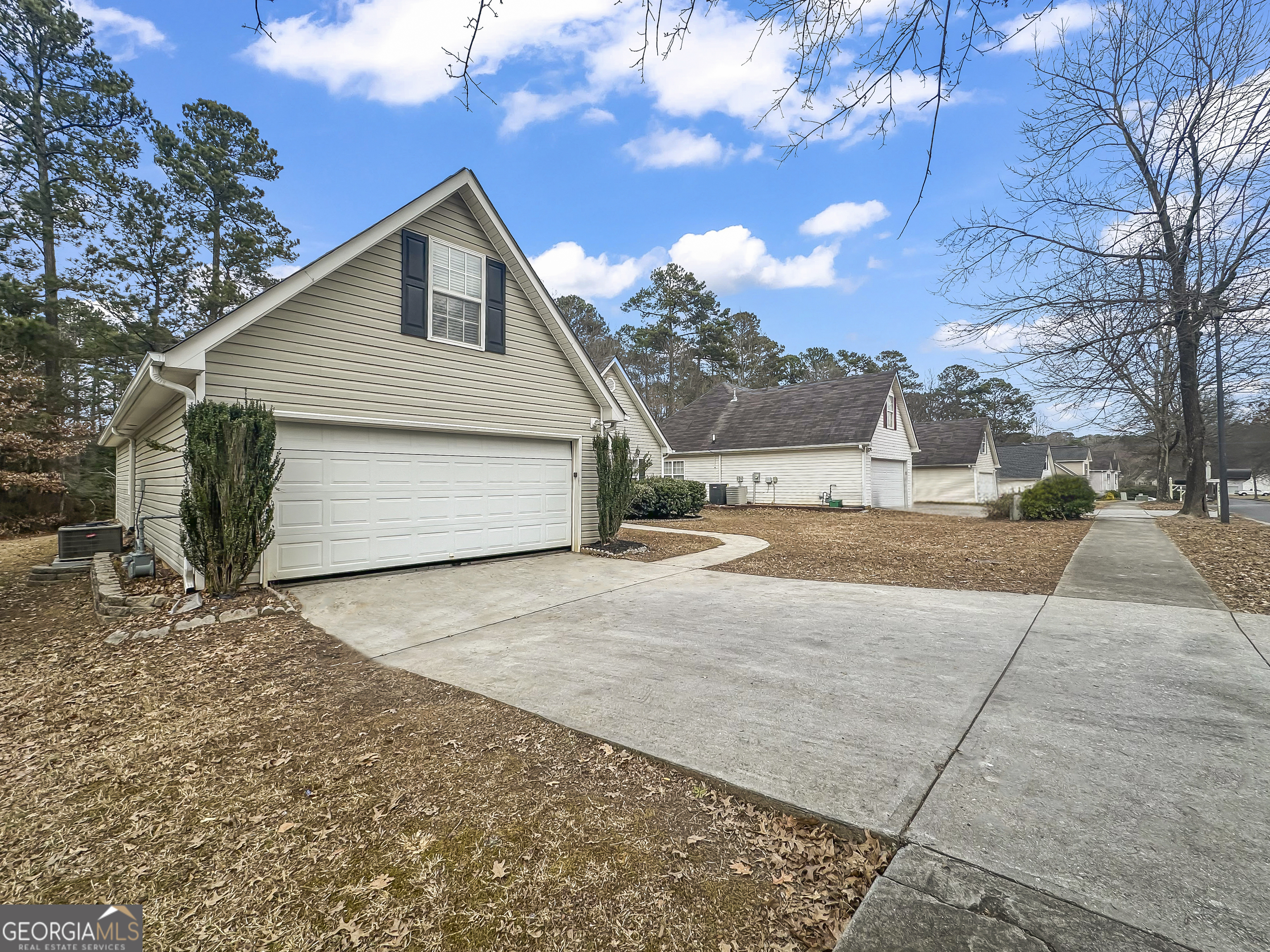 1395 Stephens Pond View Loganville, GA 30052 - Photo 2 of 20 a view of a house with a yard and garage