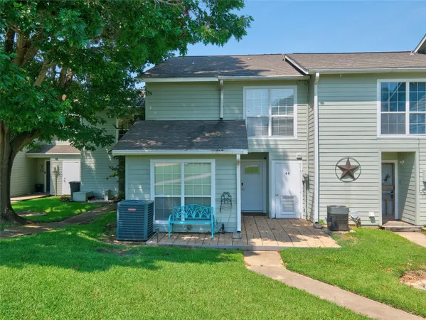 a view of a house with a yard and sitting area