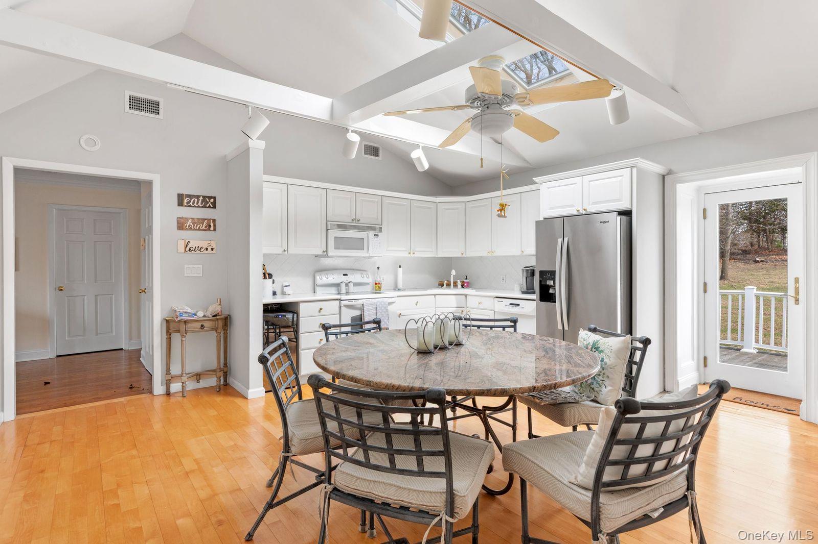 33 Beach Road Northport, NY 11768 - Photo 33 of 50 a dining room with stainless steel appliances a table and chairs