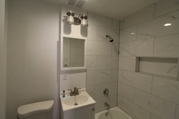 a bathroom with a toilet sink and shower