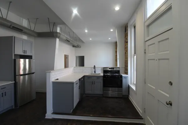 a kitchen with a stove and refrigerator