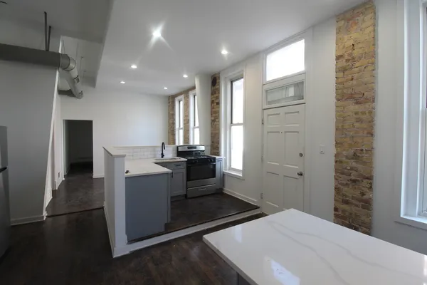 a kitchen with refrigerator and window
