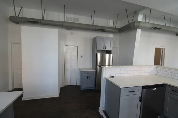 a kitchen with stainless steel appliances a refrigerator and cabinets