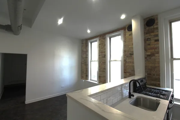 a kitchen with a sink and large window