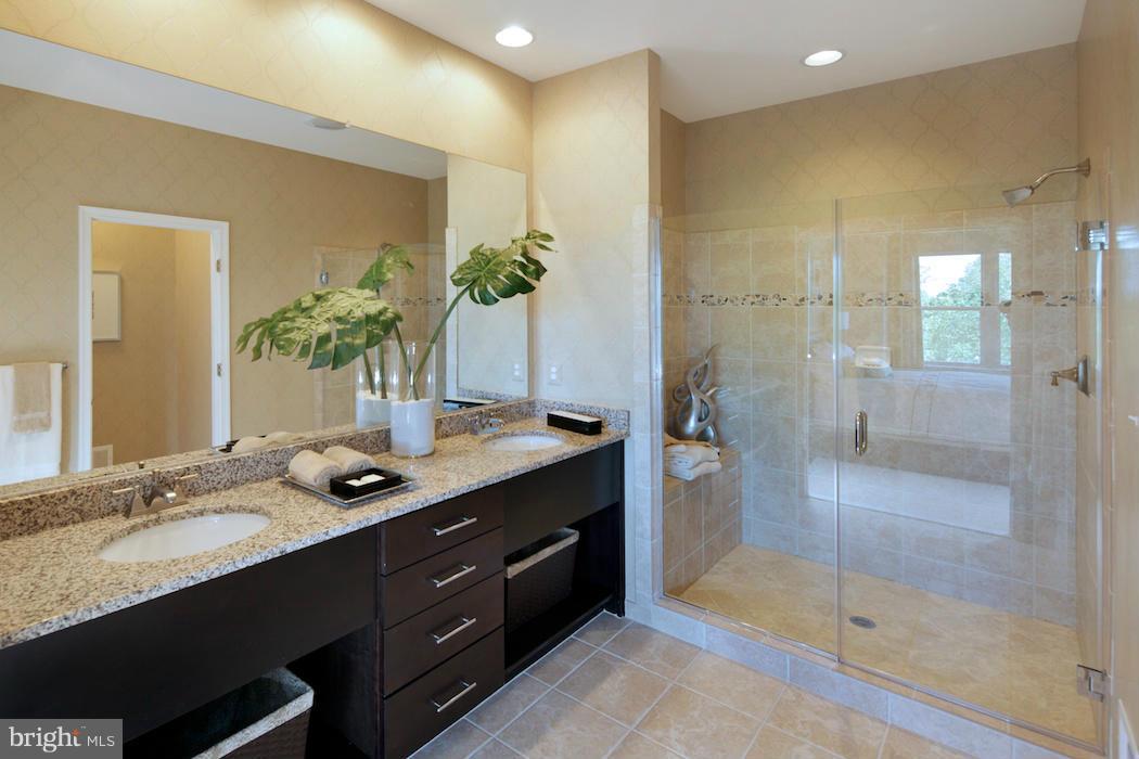 42262 Rhett Drive Ashburn, VA 20148 - Photo 13 of 30 a bathroom with a granite countertop sink mirror and shower