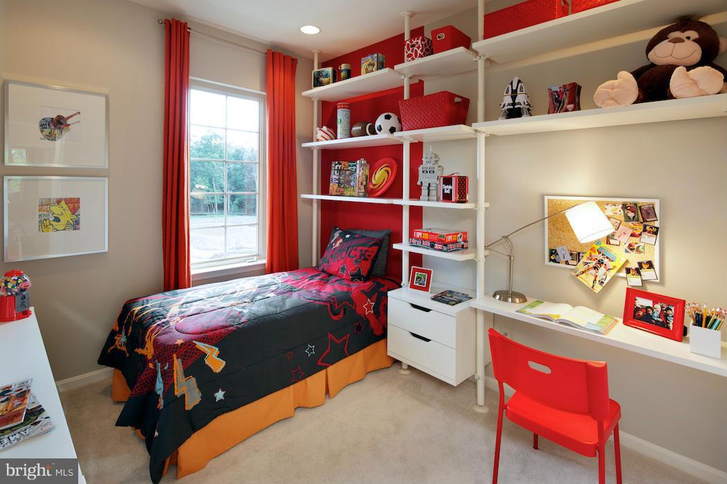 42262 Rhett Drive Ashburn, VA 20148 - Photo 14 of 30 a bedroom with a bed and a book shelf