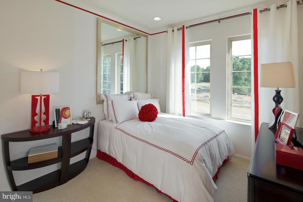 42262 Rhett Drive Ashburn, VA 20148 - Photo 15 of 30 a bedroom with a bed and wooden floor