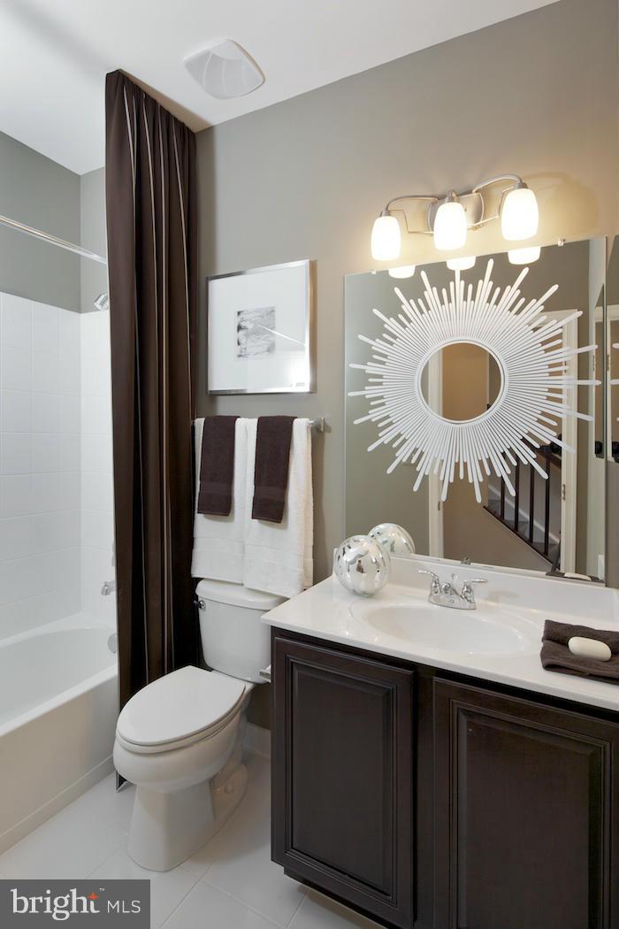 42262 Rhett Drive Ashburn, VA 20148 - Photo 19 of 30 a bathroom with a granite countertop toilet sink and mirror