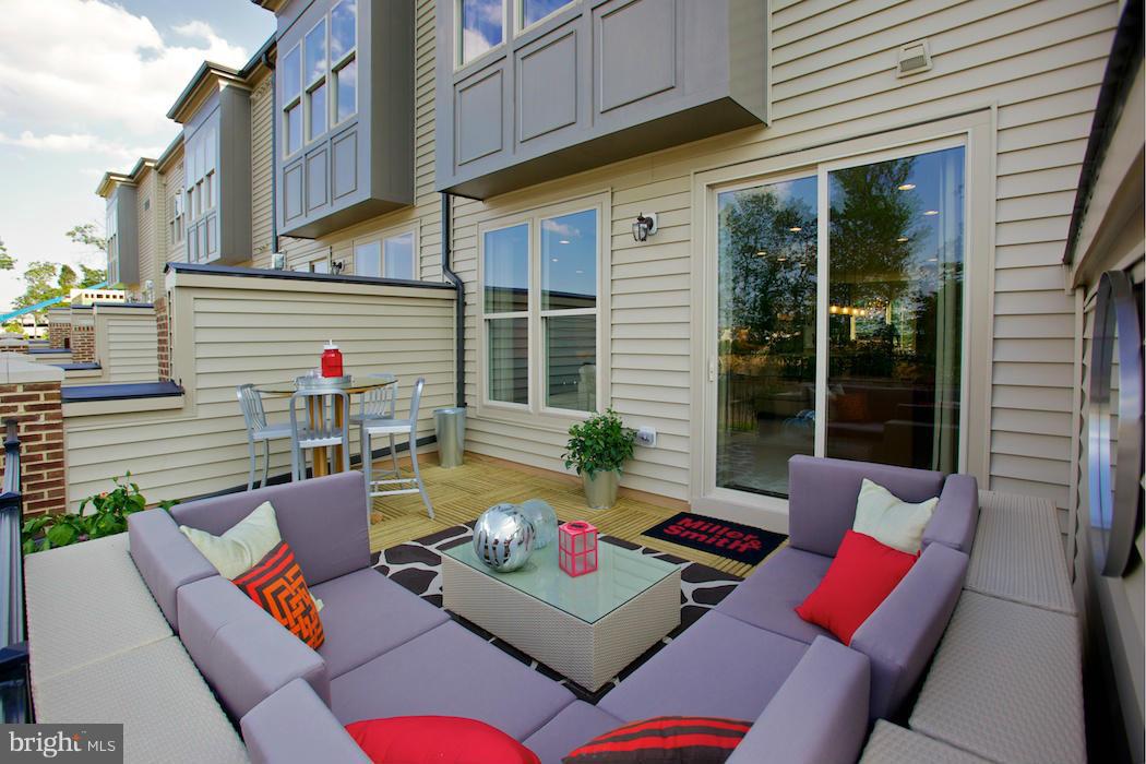 42262 Rhett Drive Ashburn, VA 20148 - Photo 21 of 30 a view of a patio with couches table and chairs and potted plants