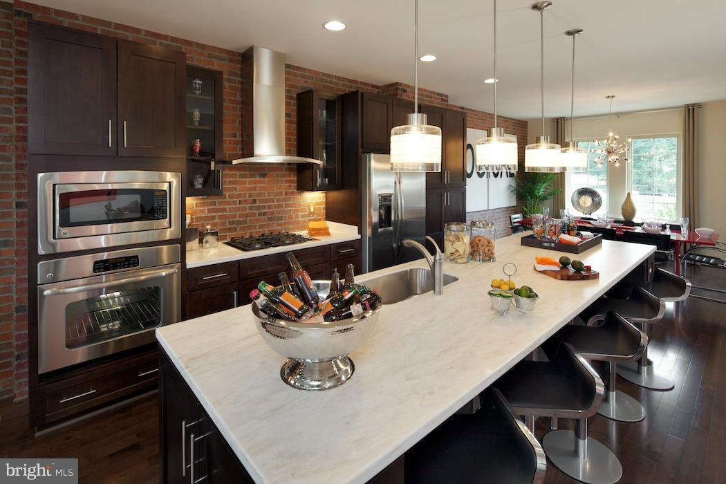 42262 Rhett Drive Ashburn, VA 20148 - Photo 4 of 30 a kitchen with a dining table chairs and refrigerator