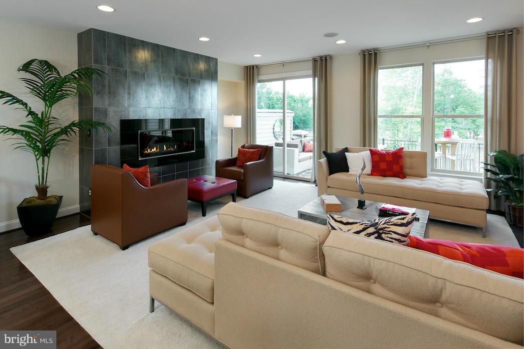 42262 Rhett Drive Ashburn, VA 20148 - Photo 7 of 30 a living room with furniture a flat screen tv and a large window