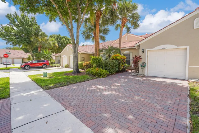 a view of a house with a yard and garage