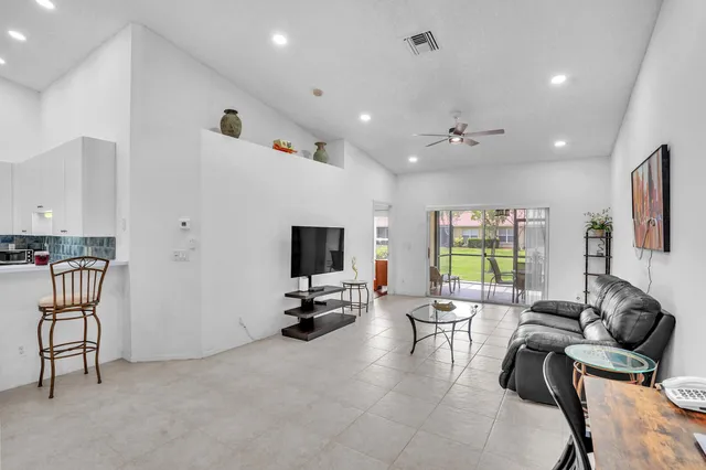 a bedroom with a bed and a large window with outer view