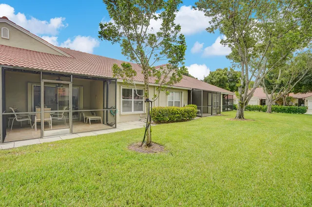 an aerial view of lake and residential houses with outdoor space